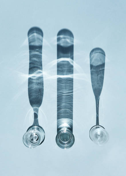 Shadows from glass objects. Transparent glasses, glasses and wineglasses. The light is sunny.