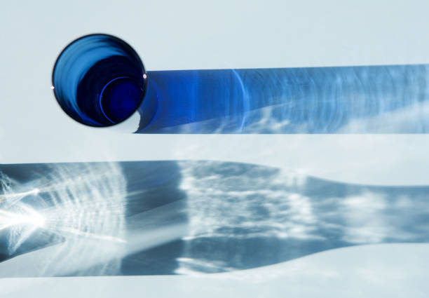 Shadows from glass objects. Blue glass and shadow from a decanter. The light is sunny.