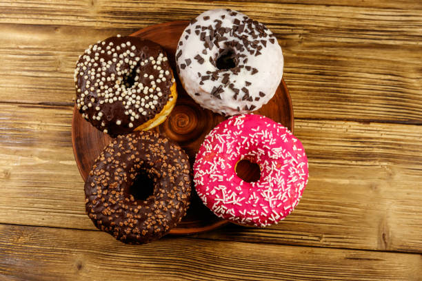 istock Tasty donuts on a wooden table. Top view 1222820215