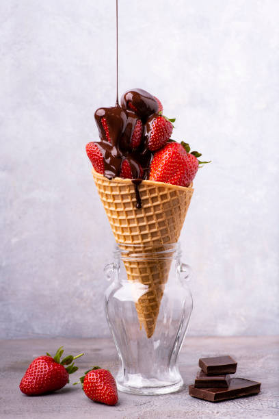 istock ice cream cone with strawberries and dark chocolate 1222820464