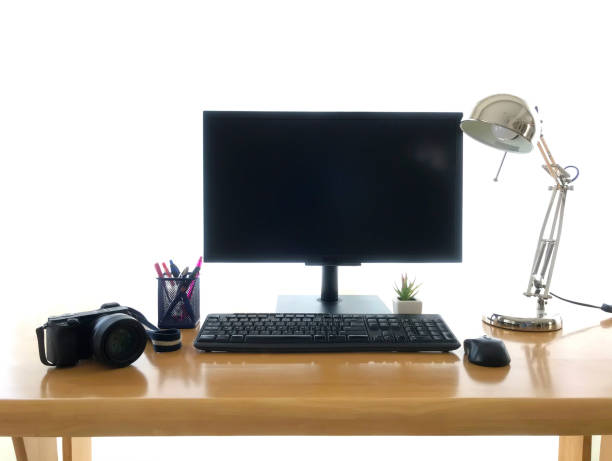 istock White screen computer in room on gray table and camera film, workplace 1222821697