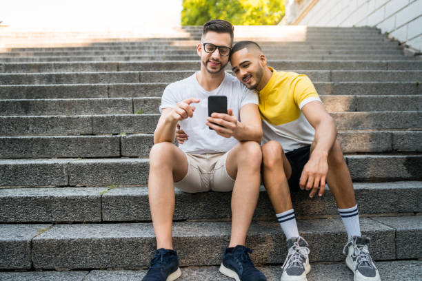 istock Gay couple spending time together while using phone. 1222821907