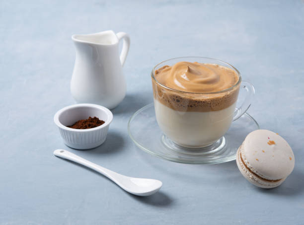 istock Korean dalgona coffee  in a glass Cup with macaroon, milk jug and instant coffee on light blue  background. Trendy  drink 1222822734