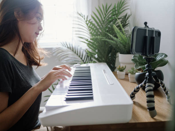 istock Millennial woman learning to playing keyboard piano at home 1222822928