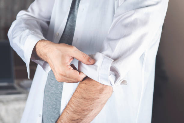istock a man straightens his sleeve on his shirt 1222823091