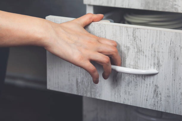 istock Woman hand pulling open wooden drawer 1222823146