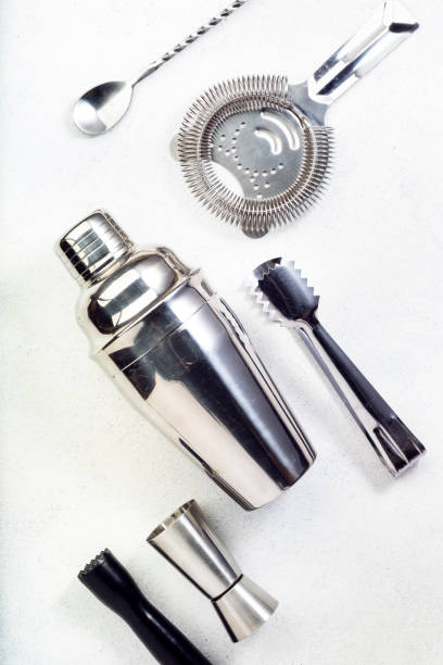 istock Steel bar tools and accessories for making cocktail. Shaker, jigger, strainer, spoon, tongs, muddler. Alcohol drink and beverages preparation concept. White background, top view, copy space 1222825296