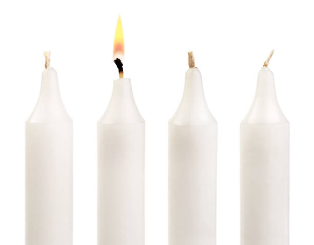 istock Paraffin candles and one burning candle on white. 1222825608