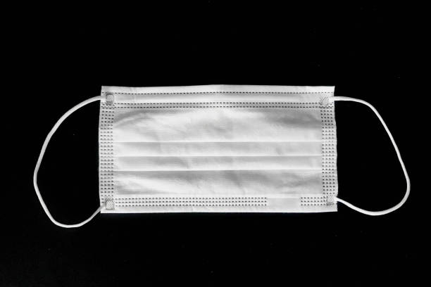 istock Disposable surgical mask on black background 1222826742
