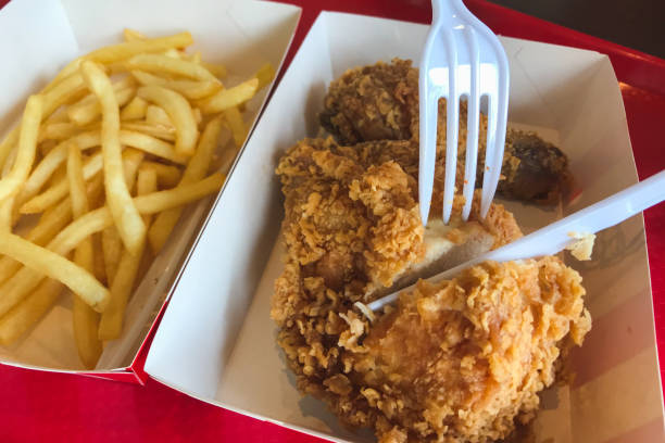 Eating fried chicken with french fries