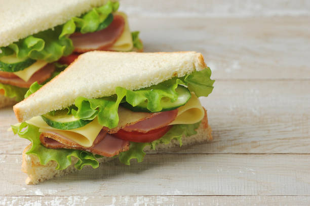 istock Sandwich with ham and cheese made of white bread. Free space for text. 1222827060