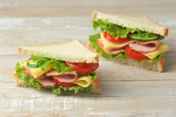 istock Ham and cheese sandwich on a light wooden background. 1222827851