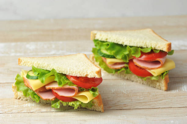 istock Ham and cheese sandwich on a light wooden background. 1222827911