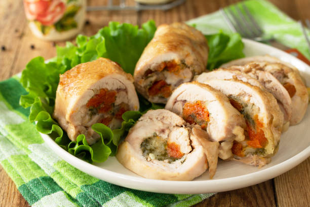 istock Festive appetizer. Chicken meatloaf with dried apricots, mozzarella and herbs on a festive table. 1222828193