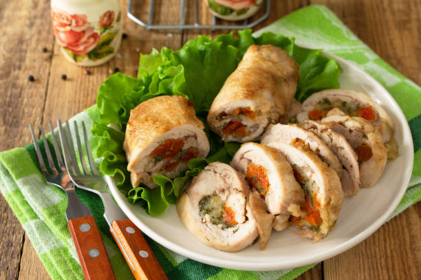 istock Festive appetizer. Chicken meatloaf with dried apricots, mozzarella and herbs on a festive table. 1222828198