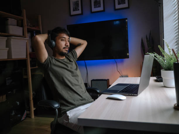 istock Young man playing video game inside a room at home. 1222829781