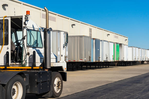 istock Trucking, tractor trailers in a warehouse freight yard. 1222830104