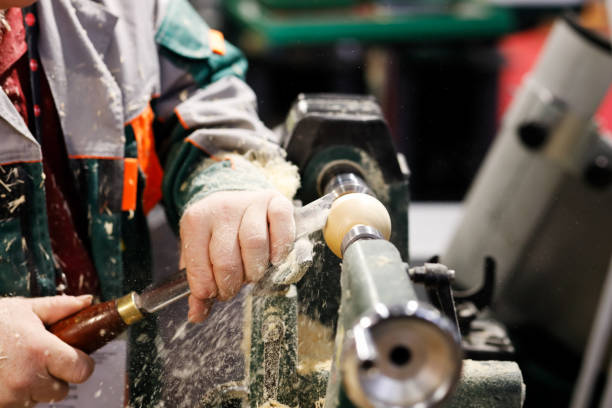 istock carpenter at work on a woodturning lathe machine 1222830930