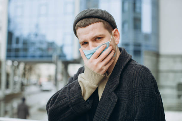 istock Man in the street wearing protective mask. 1222831560