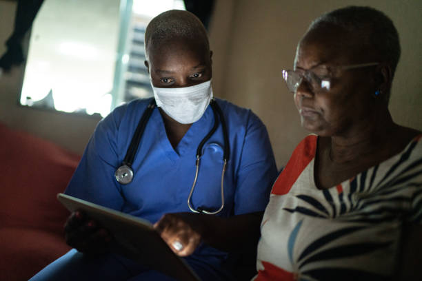 istock Health visitor and a senior woman during home visit - using digital tablet 1222832075