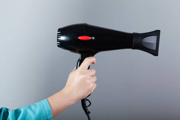 istock woman hand  hair dryer 1222832897
