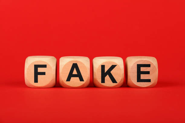 istock Wooden cubes with FAKE word over red 1222833113