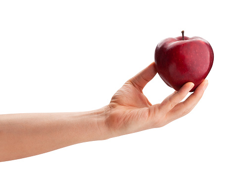 sliced red delicious apple in hand path isolated on white