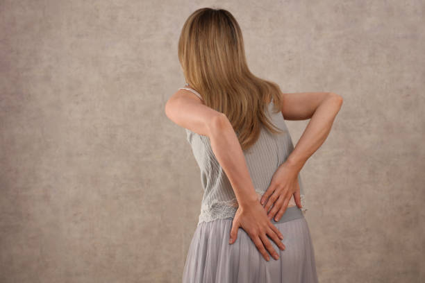 woman with lower back pain, scoliosis pain relief and health care concept. - physical injury backache occupation office imagens e fotografias de stock