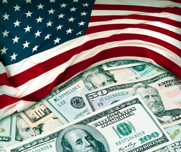 istock USA flag and cash 1222837985