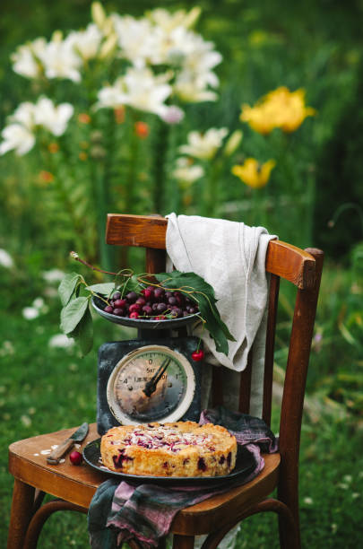 Homemade cherry pie on a wooden chair in the garden