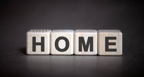 istock Text home on wooden cubes on a dark gray black background 1222840711