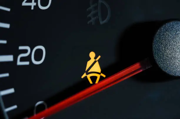 Photo of Yellow lit Warning lamp not wearing a seat belt close up