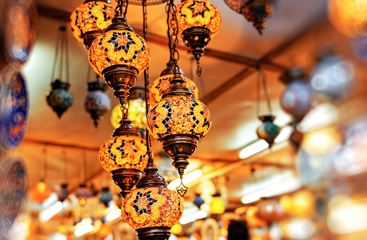 The old oriental lamp is decorated with multi-colored glass and ornament.