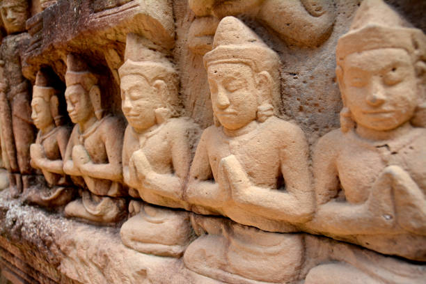 Bas-relief of men meditating in Angkor Complex, Cambodia.