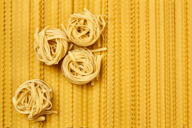 istock background of dried pasta, tagliatelle and mafaldini 1222845860