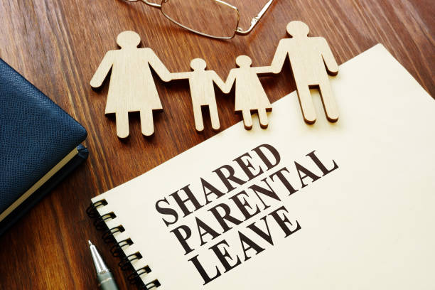 istock Shared Parental Leave papers and figures of family. 1222845964