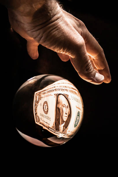 istock Dollar bill seen through crystal ball with hand 1222845966