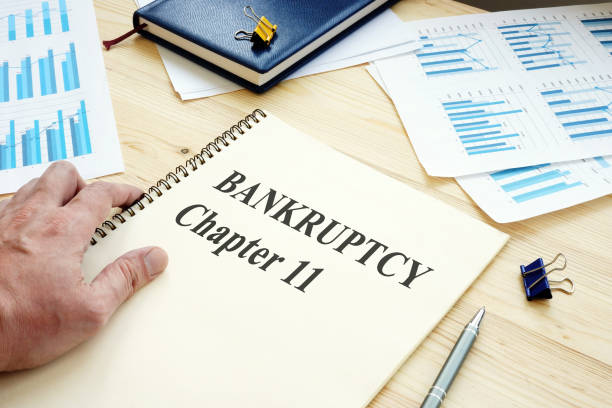 Businessman reads Bankruptcy Chapter 11 book. Businessman reads Bankruptcy Chapter 11 book. number 11 stock pictures, royalty-free photos & images