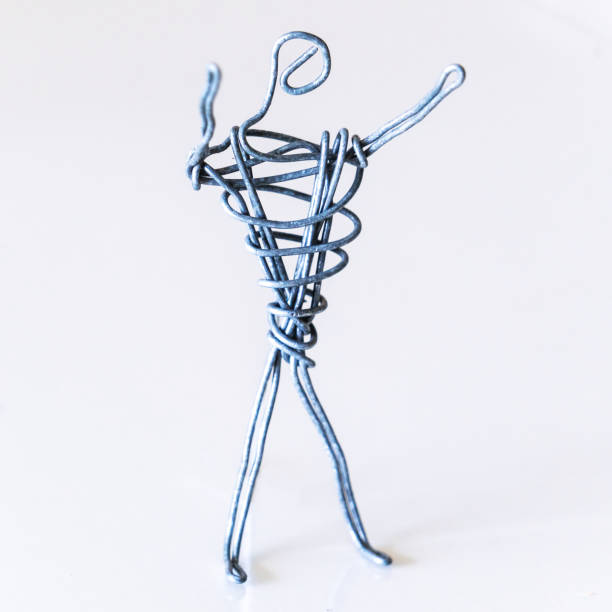 istock A man of wire is standing, raising his hands up, symbolizing success, joy, dream 1222846921