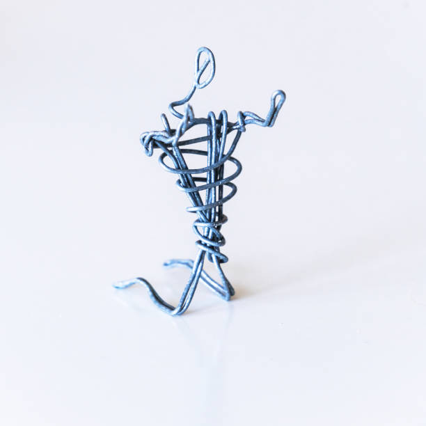 istock A man of wire is kneeling and stretched his arms forward, symbolizing a request, appeal, prayer 1222846969