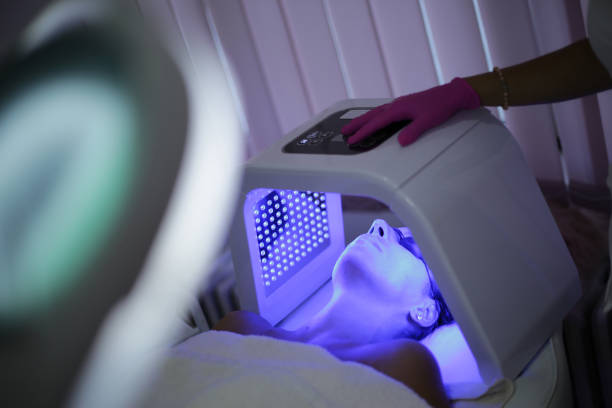 Young woman on light therapy in beauty salon. Omega Light Therapy A young woman is having phototherapy in a beauty salon. Omega Light Therapy light therapy stock pictures, royalty-free photos & images