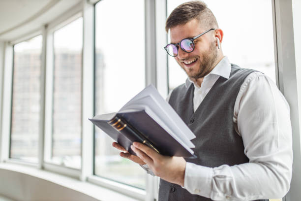istock Man reading book and listening music 1222850831