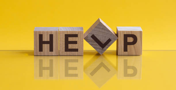 istock HELP - word from wooden blocks with letters, sorry concept, yellow background. 1222851038