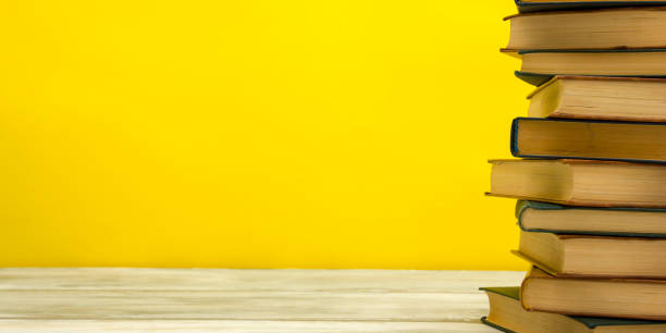 istock Open book, hardback books on wooden table. Back to school. Copy space. 1222852155