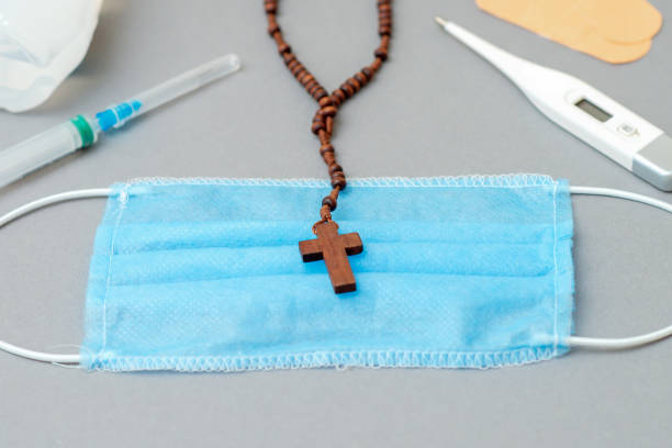 istock Medical mask with catholic cross. 1222852609