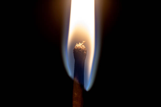 istock Burning match stick with yellow flame close up still 1222853508