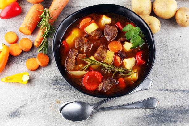 istock Meat stew with vegetables. Beef stew with potatoes, carrots and fresh herbs on table. 1222853841