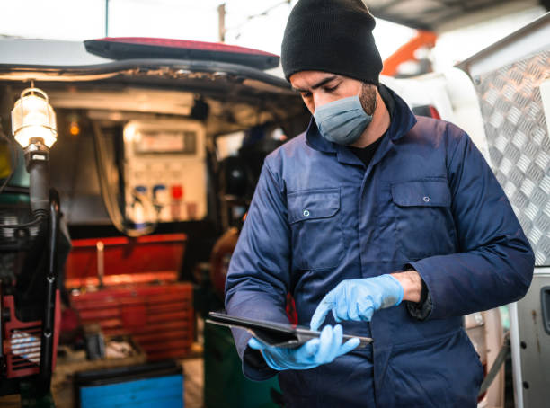 istock mechanic in front of the van with face mask 1222853907