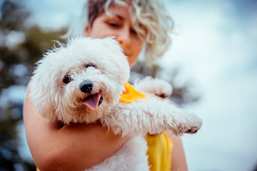 Young caucasian woman with her beloved pet outdoors