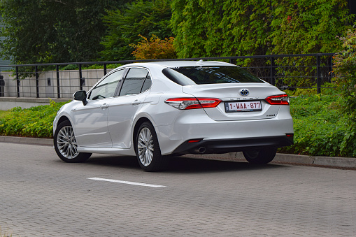 Berlin, Germany - 10 July, 2019: Toyota Camry Hybrid on a street. The Camry is one of the most popular sedan vehicles in the world.